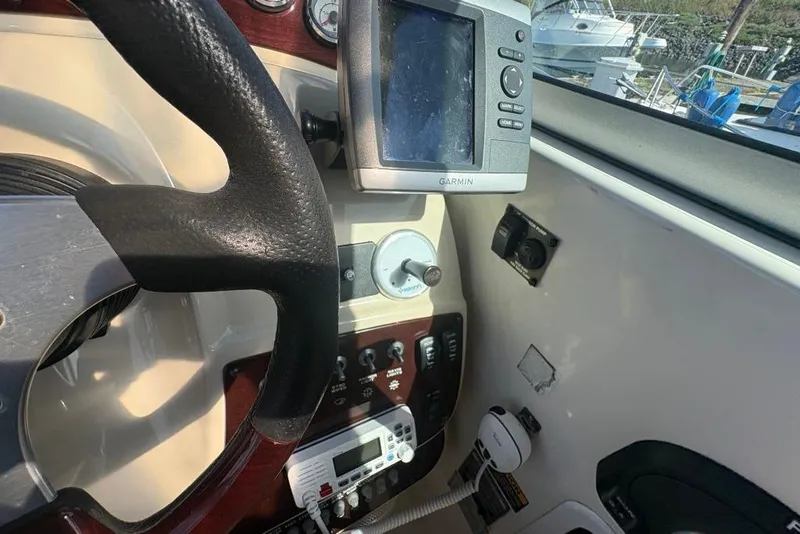 Slide: The Image of Interior of a 2008 Maxum 2700 SE boat, featuring white seating and sleek design. - 12
