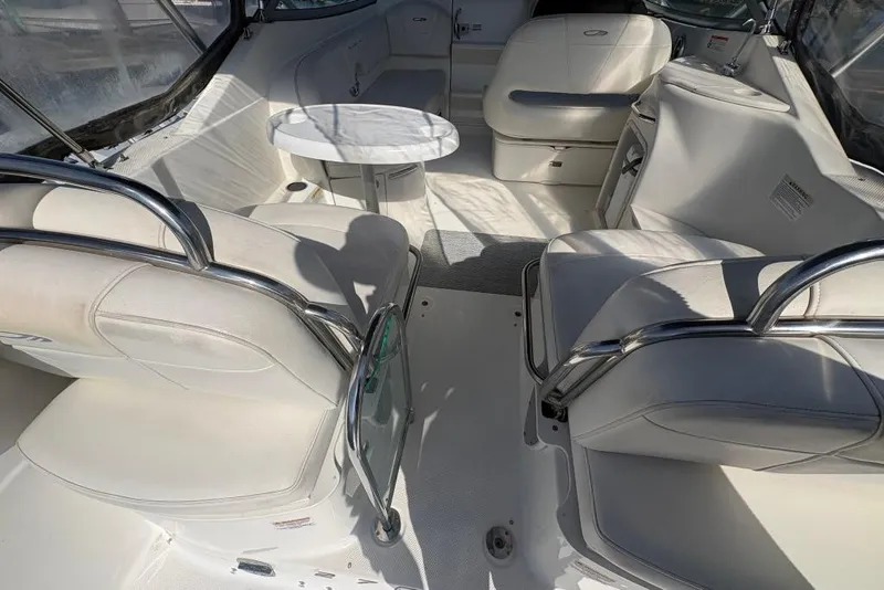 Slide: The Image of 2008 Maxum 2700 SE boat interior with white seating and a small round table. - 14