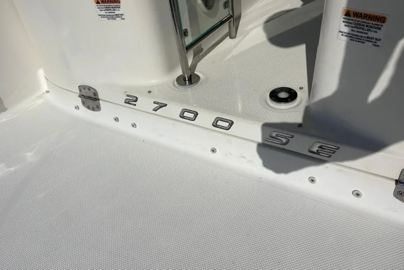 Slide: The Image of 2008 Maxum 2700 SE boat deck with model lettering and warning labels. - 15
