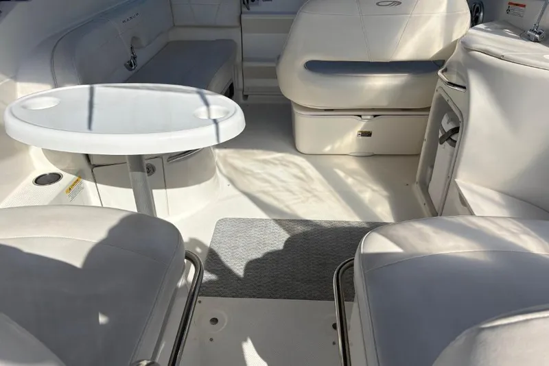 Slide: The Image of Interior of a 2008 Maxum 2700 SE boat with seating and table. - 16