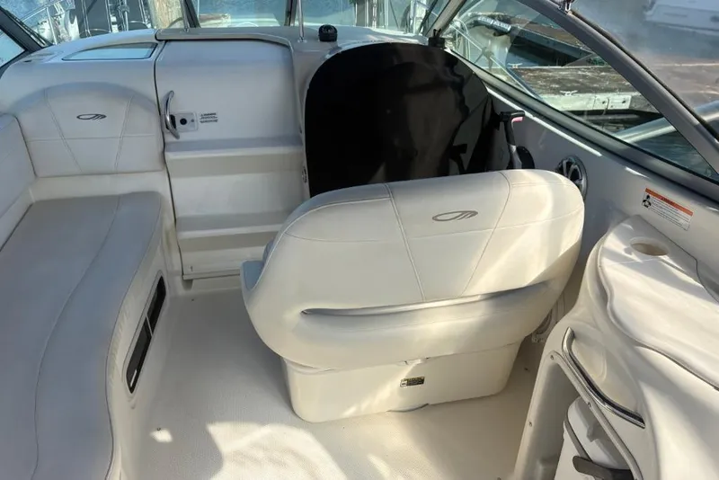 Slide: The Image of 2008 Maxum 2700 SE boat interior with white seating and helm area. - 18