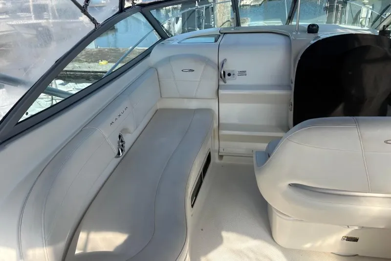 Slide: The Image of Interior of a 2008 Maxum 2700 SE boat, featuring white seating and sleek design. - 19
