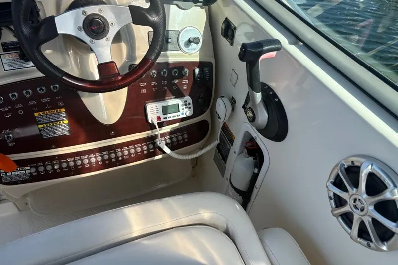 Slide: The Image of 2008 Maxum 2700 SE boat cockpit with steering wheel and control panel. - 22