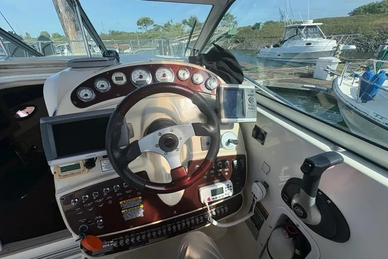 Slide: The Image of 2008 Maxum 2700 SE boat cockpit with steering wheel, gauges, and navigation equipment. - 23
