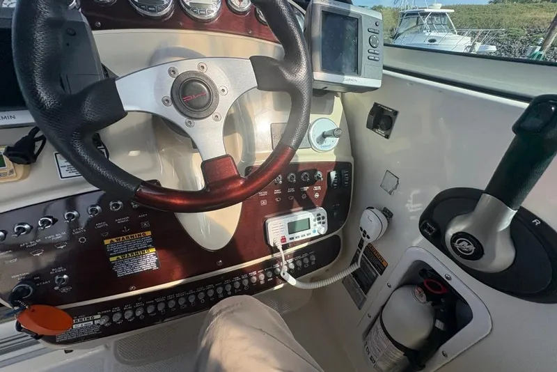 Slide: The Image of 2008 Maxum 2700 SE boat dashboard with steering wheel, controls, and navigation equipment. - 25