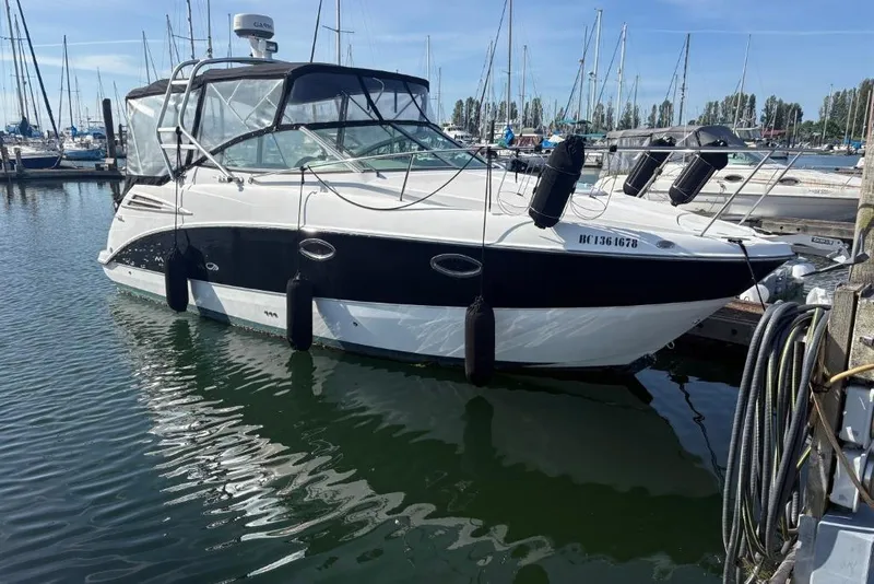 Slide: The Image of 2008 Maxum 2700 SE boat docked in marina, surrounded by other vessels. - 3