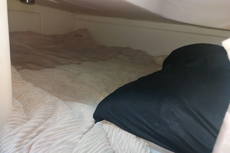Slide: The Image of Cozy sleeping area inside a 2008 Maxum 2700 SE boat cabin. - 31