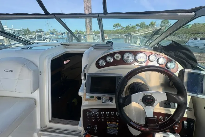 Slide: The Image of 2008 Maxum 2700 SE boat cockpit with steering wheel and navigation instruments. - 37