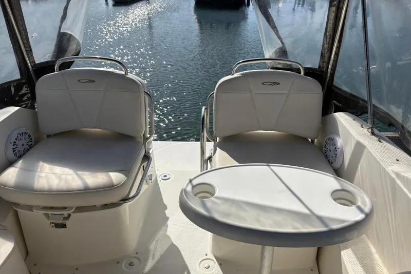 Slide: The Image of 2008 Maxum 2700 SE boat interior with seating and table, overlooking water. - 39