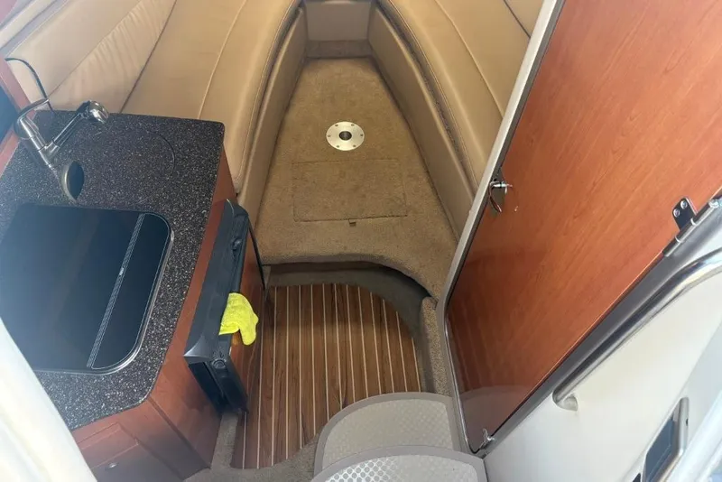 Slide: The Image of Interior of 2008 Maxum 2700 SE boat with kitchenette and seating area. - 41