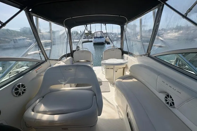Slide: The Image of 2008 Maxum 2700 SE boat interior with seating and table, docked at marina. - 43