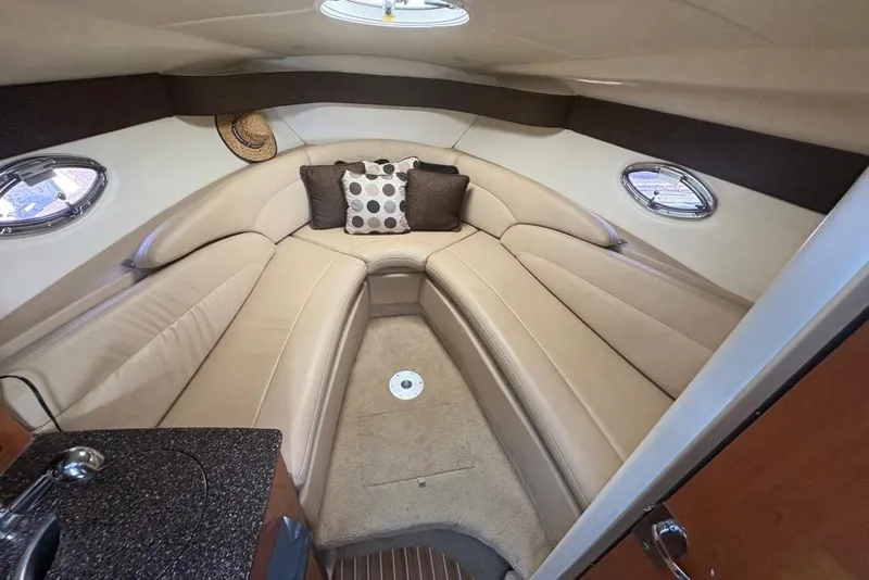 Slide: The Image of Luxurious interior of 2008 Maxum 2700 SE boat with beige seating and decorative pillows. - 44