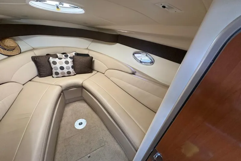 Slide: The Image of Interior of a 2008 Maxum 2700 SE boat with beige seating and decorative pillows. - 45