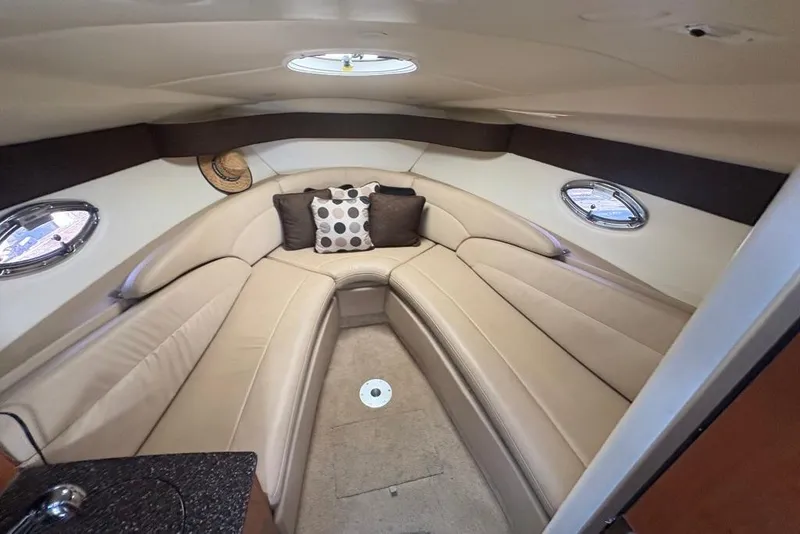 Slide: The Image of Luxurious interior of 2008 Maxum 2700 SE boat with beige seating and decorative pillows. - 46