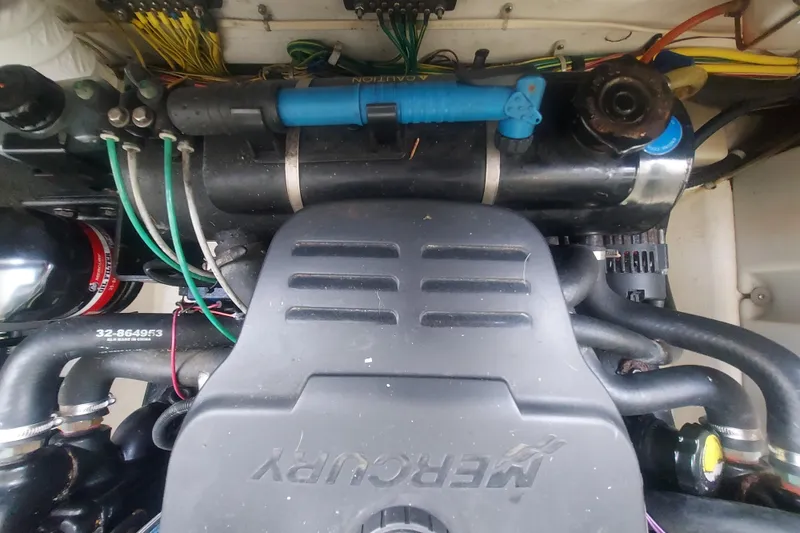 Slide: The Image of Engine compartment of a 2008 Maxum 2700 SE boat with visible wiring and components. - 48
