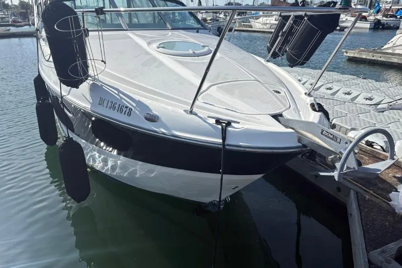 Slide: The Image of 2008 Maxum 2700 SE boat docked at marina, featuring sleek design and black fenders. - 5