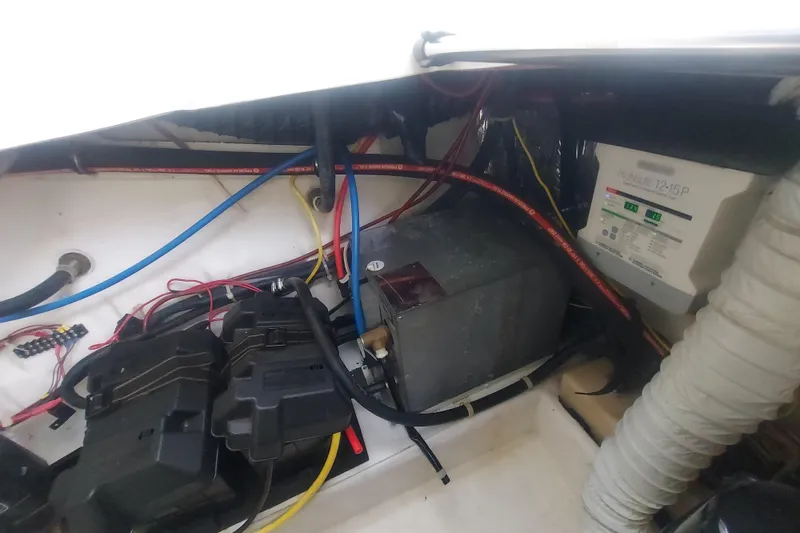 Slide: The Image of Engine compartment of a 2008 Maxum 2700 SE boat, showing wiring and battery setup. - 50