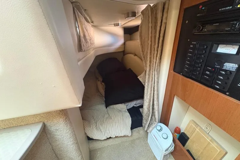 Slide: The Image of Cozy cabin interior of 2008 Maxum 2700 SE boat with bedding and control panel. - 55