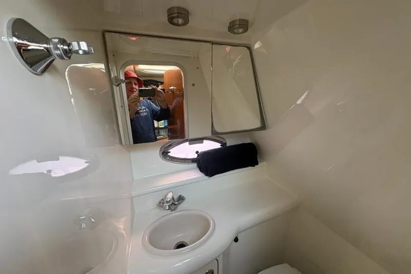Slide: The Image of 2008 Maxum 2700 SE boat bathroom with sink, mirror, and porthole window. - 60
