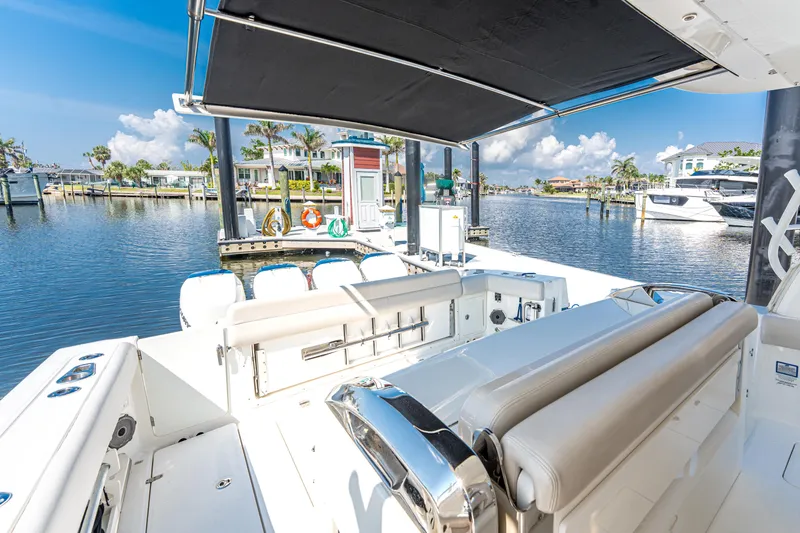 Slide: The Image of 2019 Boston Whaler 420 Outrage boat interior at a sunny marina. - 24