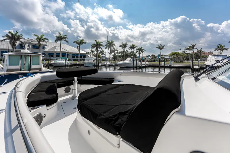 Slide: The Image of 2019 Boston Whaler 420 Outrage boat docked, featuring spacious seating and sleek design. - 35