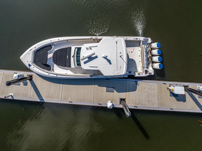 Slide: The Image of Aerial view of 2019 Boston Whaler 420 Outrage docked, showcasing sleek design and powerful engines. - 42