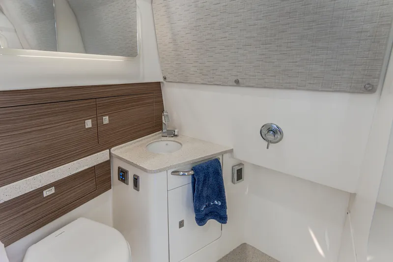 Slide: The Image of Modern bathroom interior on 2019 Boston Whaler 420 Outrage boat, featuring sink and storage. - 45