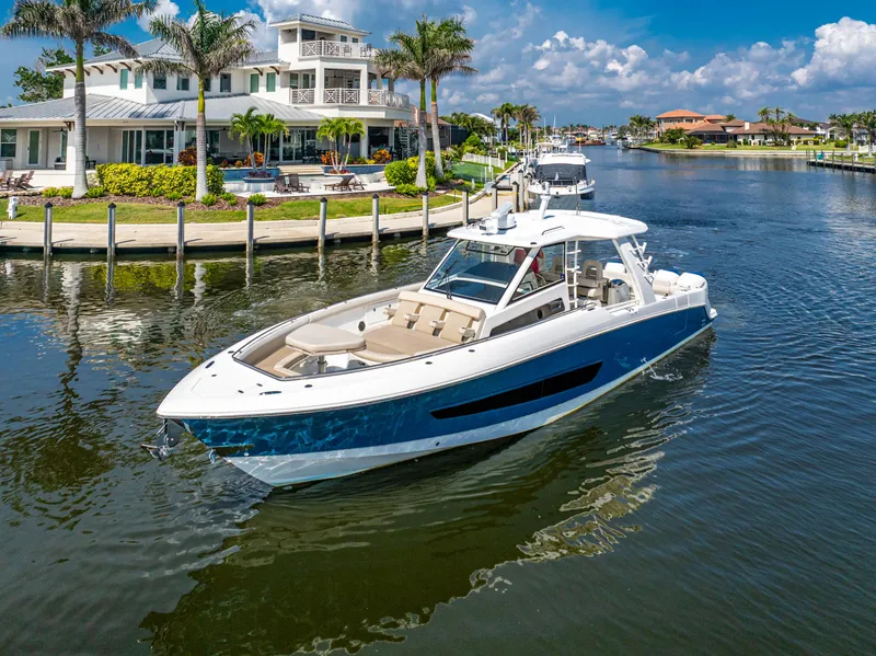 Slide: The Image of 2019 Boston Whaler 420 Outrage cruising in a scenic waterfront setting. - 47