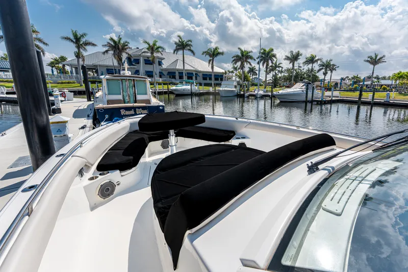 Slide: The Image of 2019 Boston Whaler 420 Outrage docked at marina with palm trees and boats. - 6