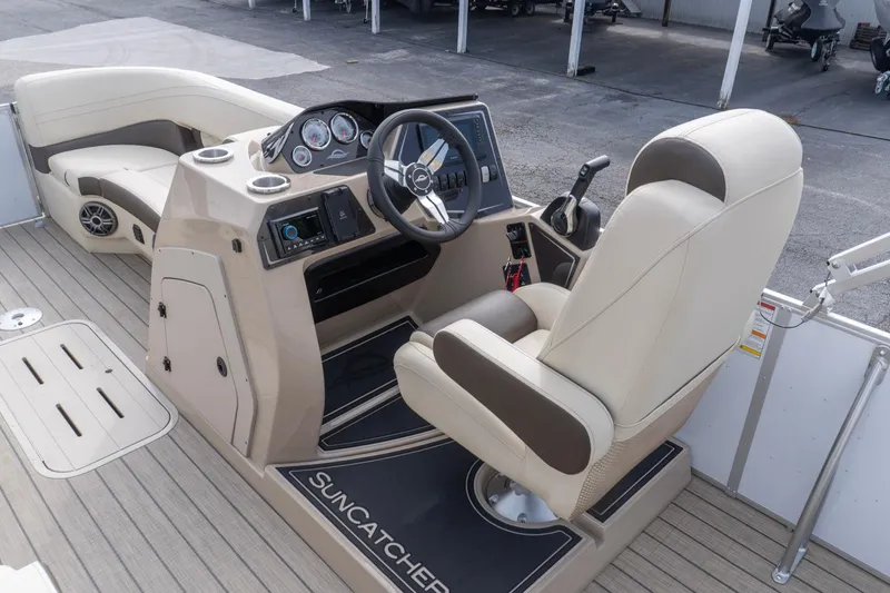 Slide: The Image of SunCatcher Fusion 324SL 2026 boat interior with steering console and seating. - 11