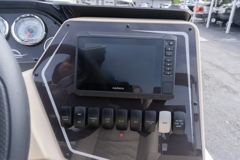 Slide: The Image of Dashboard of 2026 SunCatcher Fusion 324SL with Garmin display and control switches. - 12