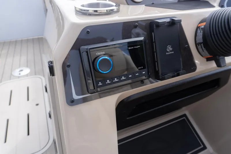 Slide: The Image of Control panel of 2026 SunCatcher Fusion 324SL boat with Clarion audio system. - 13
