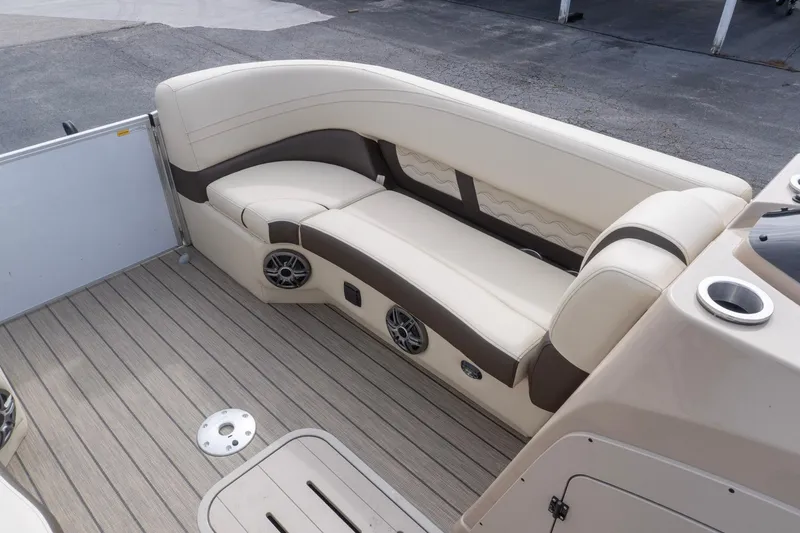 Slide: The Image of Luxurious seating area on 2026 SunCatcher Fusion 324SL boat with beige upholstery and speakers. - 19
