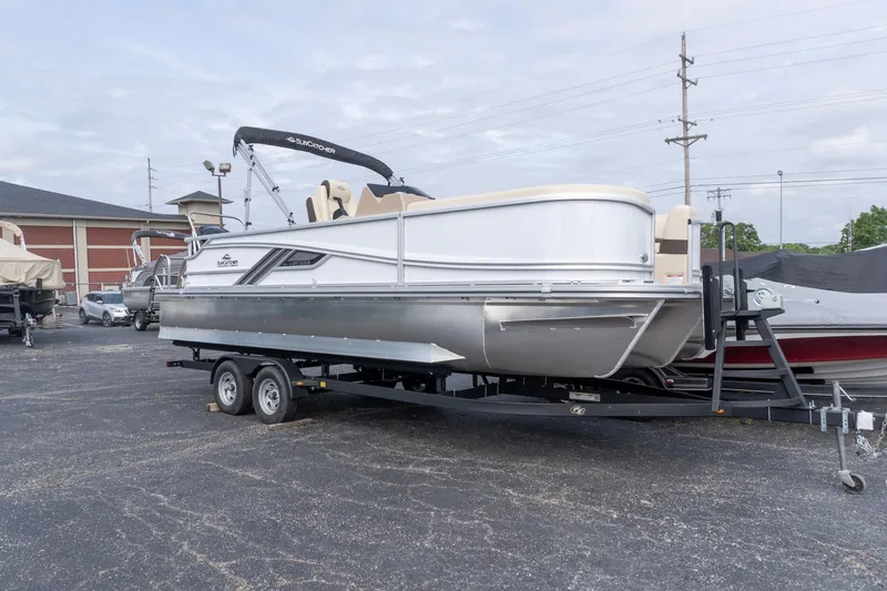 Slide: The Image of 2026 SunCatcher Fusion 324SL pontoon boat on trailer in parking lot. - 2