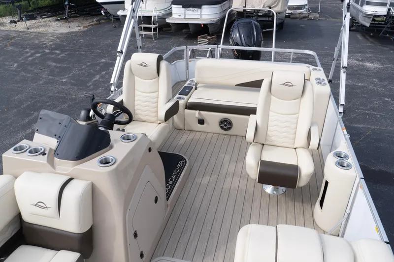 Slide: The Image of Luxurious interior of 2026 SunCatcher Fusion 324SL pontoon boat with plush seating and modern helm. - 22