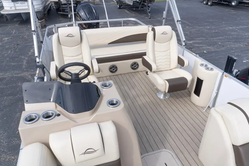 Slide: The Image of 2026 SunCatcher Fusion 324SL boat interior with beige seating and modern helm design. - 23