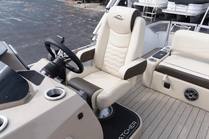 Slide: The Image of Luxurious interior of 2026 SunCatcher Fusion 324SL boat with plush seating and modern steering. - 25