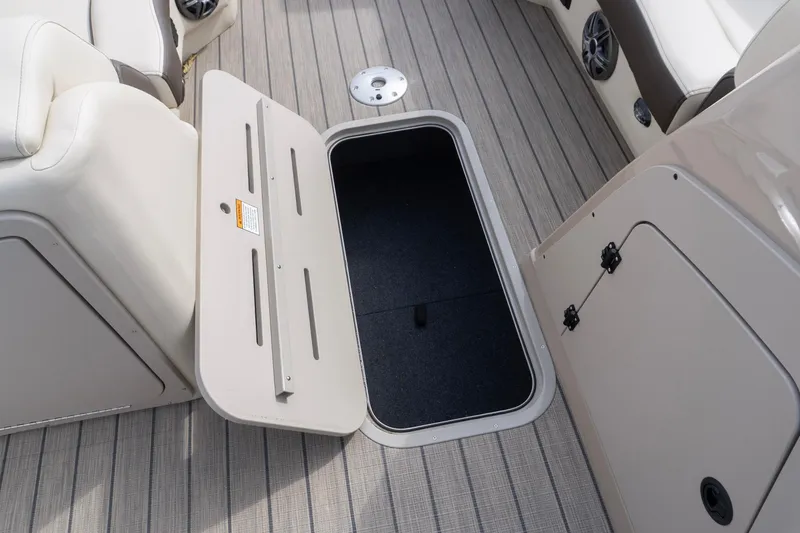 Slide: The Image of Open storage compartment on SunCatcher Fusion 324SL boat, 2026 model, with sleek interior design. - 28
