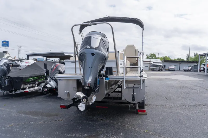 Slide: The Image of 2026 SunCatcher Fusion 324SL pontoon boat with powerful outboard motor in a dealership lot. - 3
