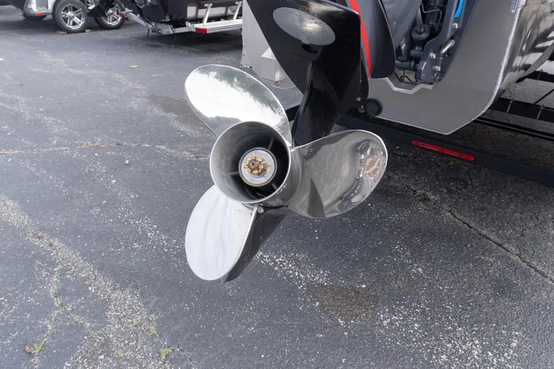 Slide: The Image of Close-up of a SunCatcher Fusion 324SL 2026 boat propeller on pavement. - 4