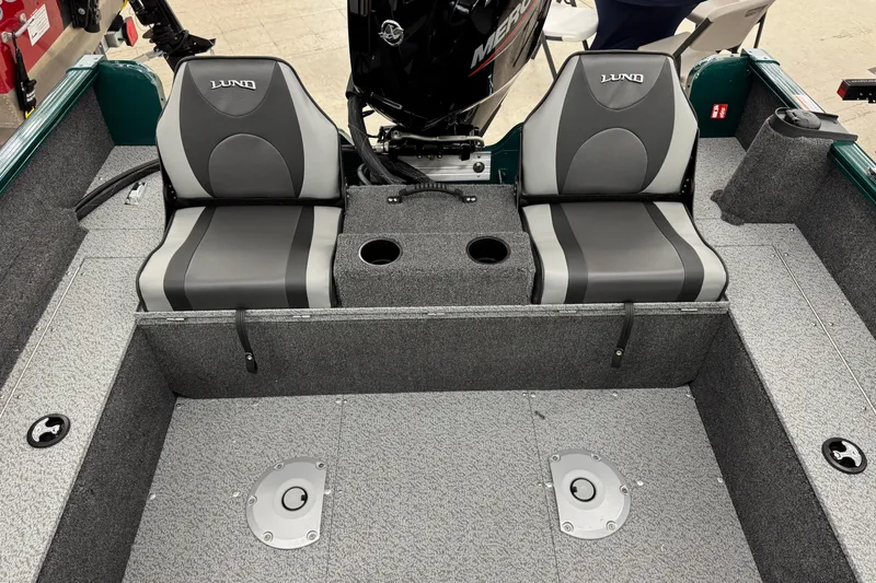 Slide: The Image of 2026 Lund 1650 Rebel XL Sport boat interior with two seats and motor. - 14