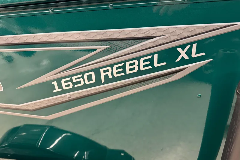 Slide: The Image of 2026 Lund 1650 Rebel XL Sport boat logo on teal background. - 16