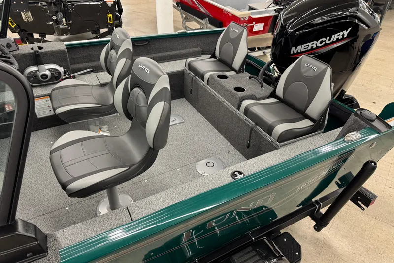 Slide: The Image of 2026 Lund 1650 Rebel XL Sport boat interior with Mercury engine and four seats. - 5