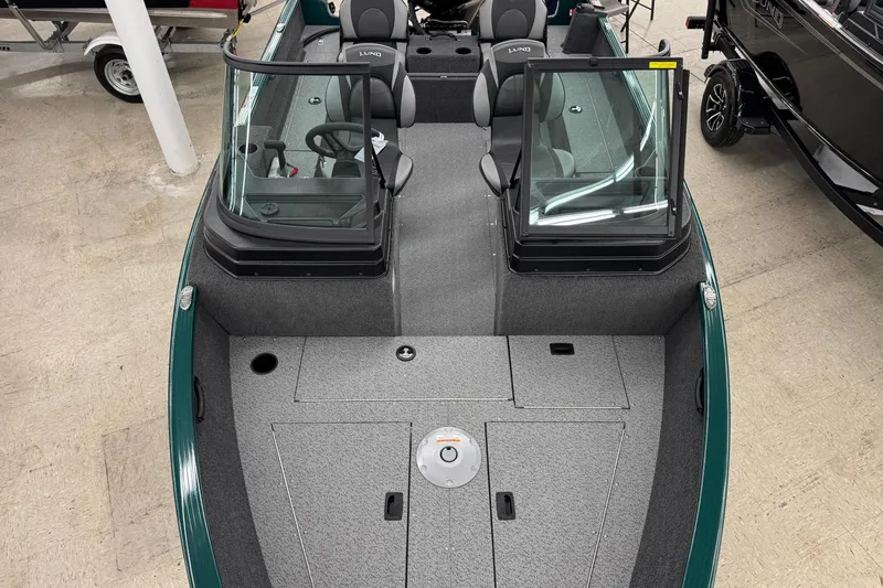 Slide: The Image of 2026 Lund 1650 Rebel XL Sport boat interior with dual consoles and seating. - 9