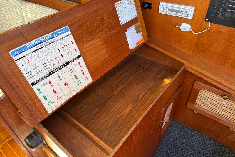 Slide: The Image of 1985 S2 11.0 meter A yacht interior with boating safety instructions and radio panel. - 16
