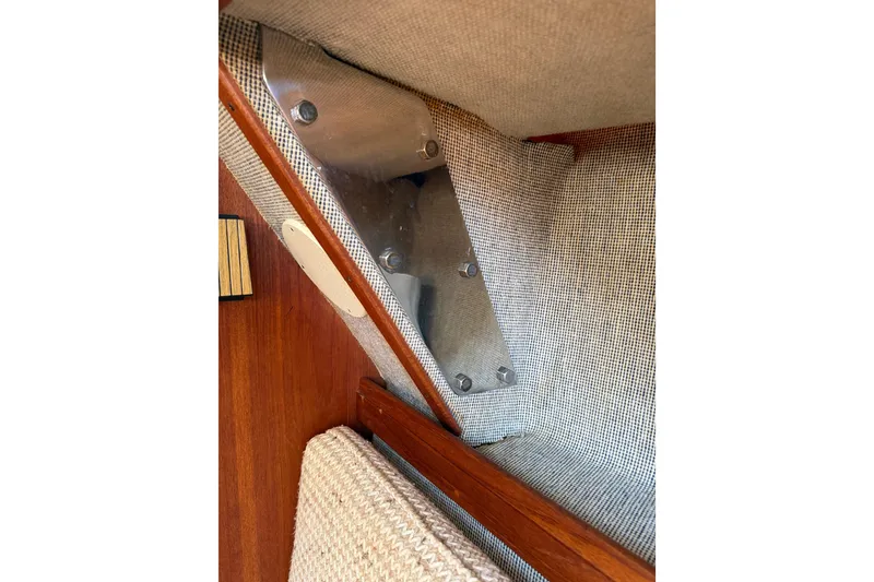 Slide: The Image of Interior detail of 1985 S2 11.0 meter A sailboat, showcasing wood and fabric elements. - 17