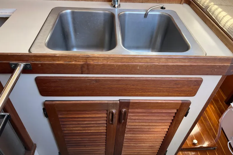 Slide: The Image of 1985 S2 11.0 meter A yacht kitchen sink with wooden cabinetry. - 25