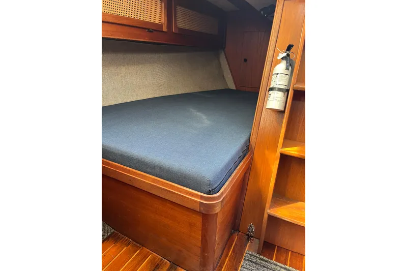 Slide: The Image of Interior cabin of 1985 S2 11.0 meter A sailboat with wooden finish and fire extinguisher. - 29