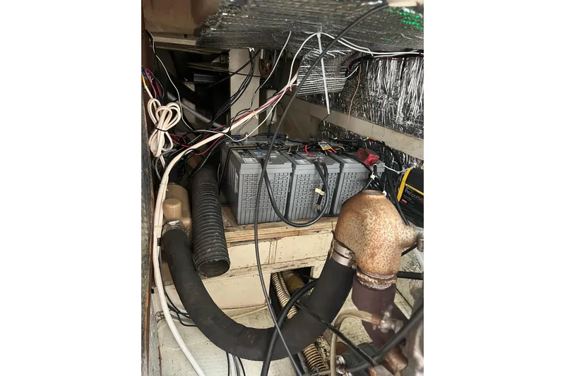 Slide: The Image of Engine compartment of a 1985 S2 11.0 meter A sailboat with wiring and battery. - 31