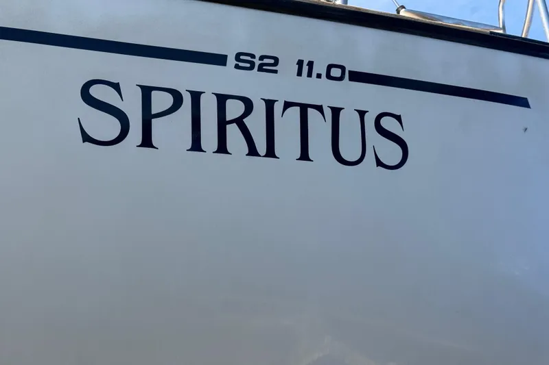 Slide: The Image of 1985 S2 11.0 meter A sailboat named "Spiritus" with bold lettering on the hull. - 39